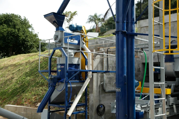 A blue industrial machine is seen outdoors